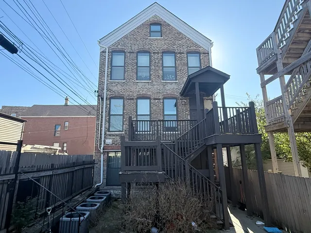 a front view of a house with iron stairs