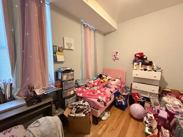 a bedroom with furniture and a wooden floor