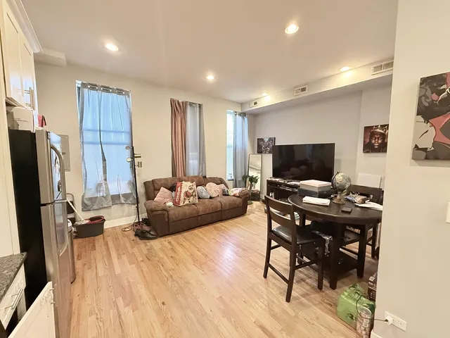 a view of a workspace with furniture and a flat screen tv