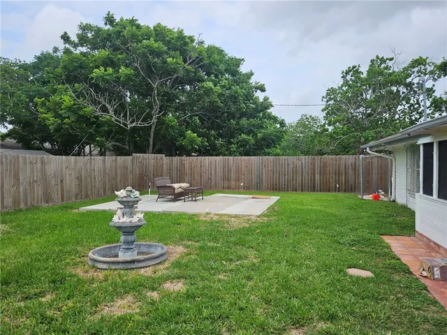 a view of a backyard with a garden and swing