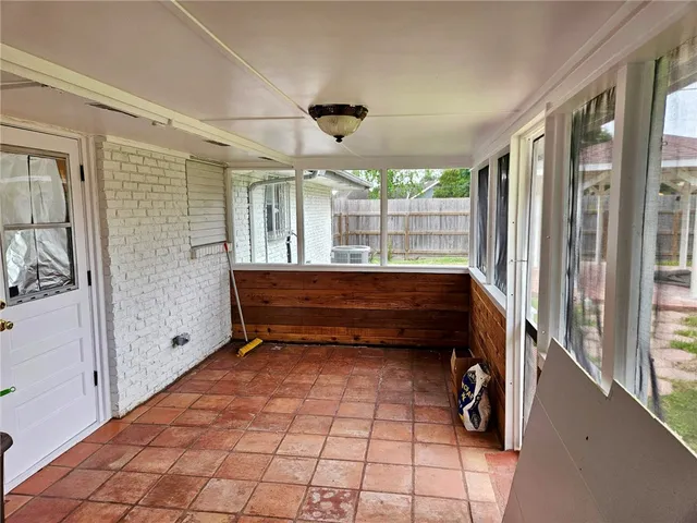 a room with a large window and pool table