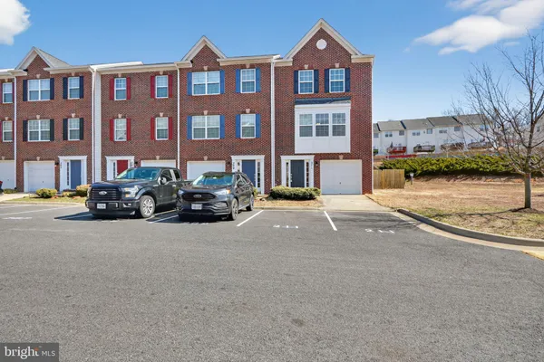 a city street lined with buildings and cars parked in front of it