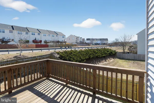 a view of a house with a wooden bench
