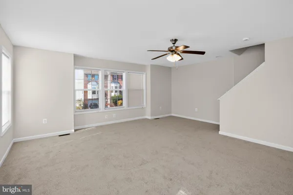a kitchen with stainless steel appliances granite countertop a refrigerator a sink a stove and a microwave
