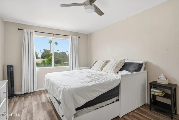 a bedroom with a bed and a chandelier