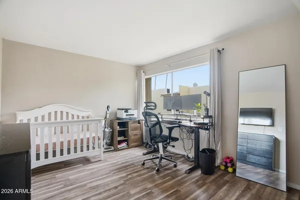 a view of a workspace with furniture and a window