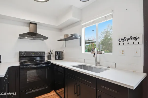 a kitchen with a sink and a stove top oven