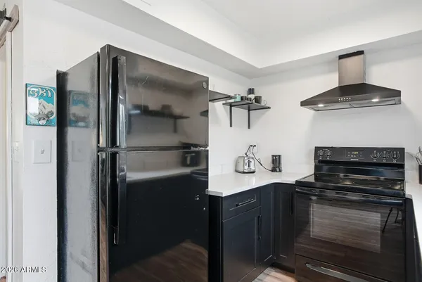 a kitchen with stainless steel appliances granite countertop a refrigerator and a stove