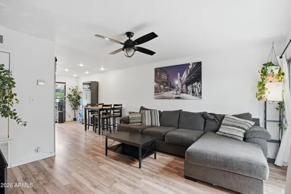 a living room with furniture and a wooden floor