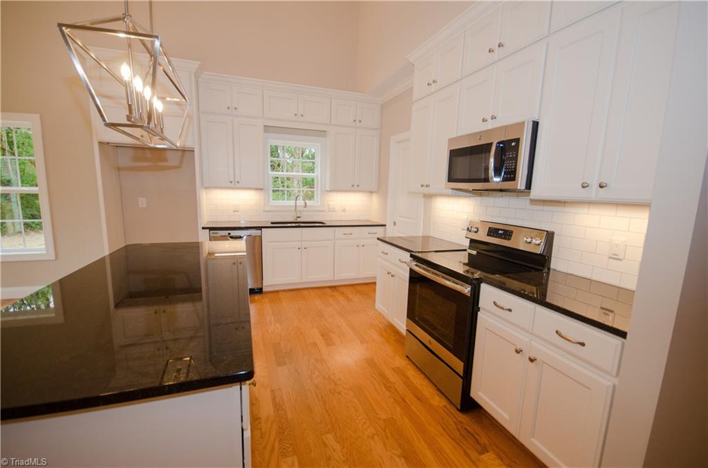 3589 Transou Road Pfafftown, NC 27040 - Photo 29 of 29 Open Floor plan, Modern Kitchen with Granite Countertops, Spacious Island and Stainless Steel Appliances.