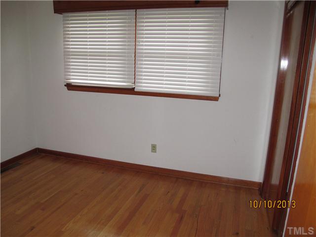 3912 Donna Road Raleigh, NC 27604 - Photo 3 of 13 an empty room with wooden floor and a window