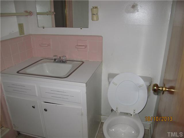 3912 Donna Road Raleigh, NC 27604 - Photo 5 of 13 a bathroom with a granite countertop toilet sink and mirror
