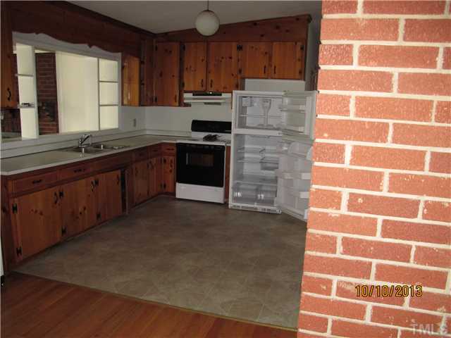 3912 Donna Road Raleigh, NC 27604 - Photo 7 of 13 a kitchen with cabinets and stainless steel appliances