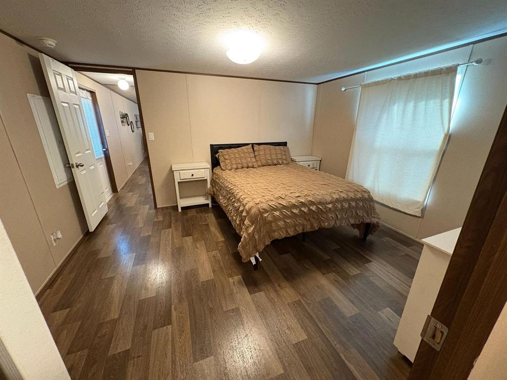 11093 Alta Vista Road Fort Worth, TX 76244 - Photo 5 of 10 a bedroom with a bed and a mirror