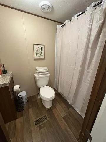 a bedroom with a bed and a mirror