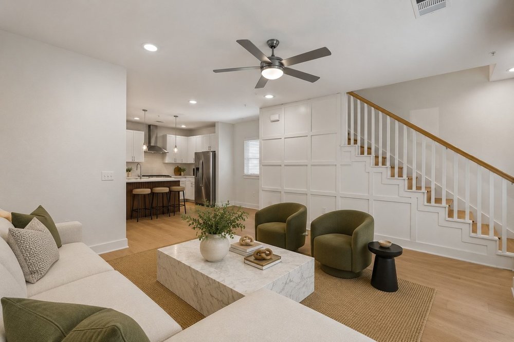 2827 Manor Road, Unit 2201 Austin, TX 78722 - Photo 5 of 40 Open-concept living area featuring light wood-finish flooring, recessed lighting, a modern ceiling fan, and a staircase with white balusters and a wood handrail