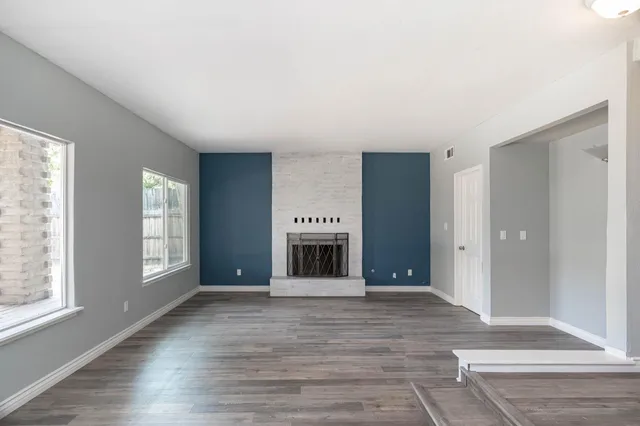 a view of a livingroom with a fireplace and window