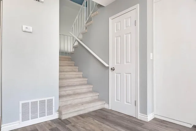a view of entryway with wooden floor and stairs