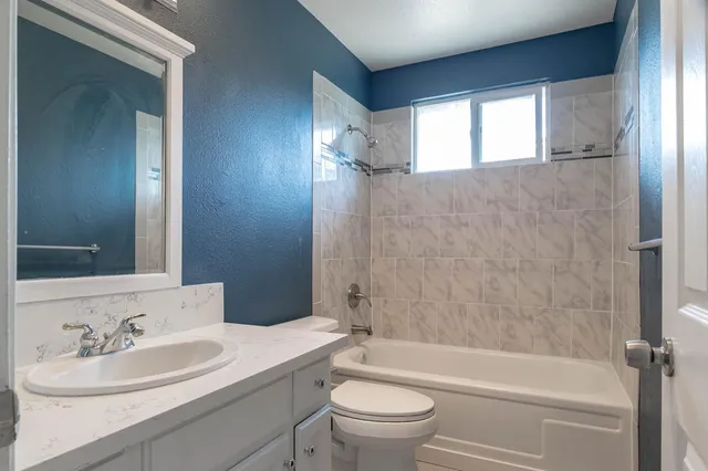 a view of a bathroom with a shower and a sink