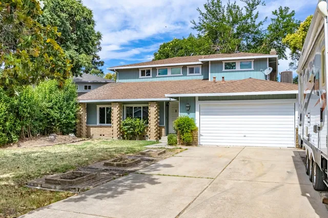 a front view of a house with a yard and porch