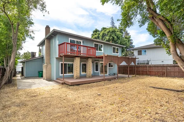 a view of a house with wooden fence