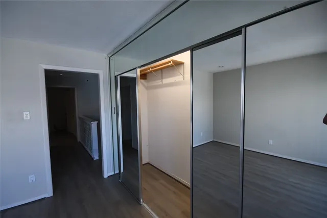 an empty room with wooden floor