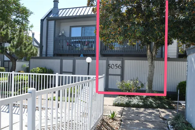 a view of sign board with flower plants
