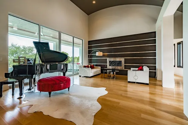 a living room with furniture a rug and white walls