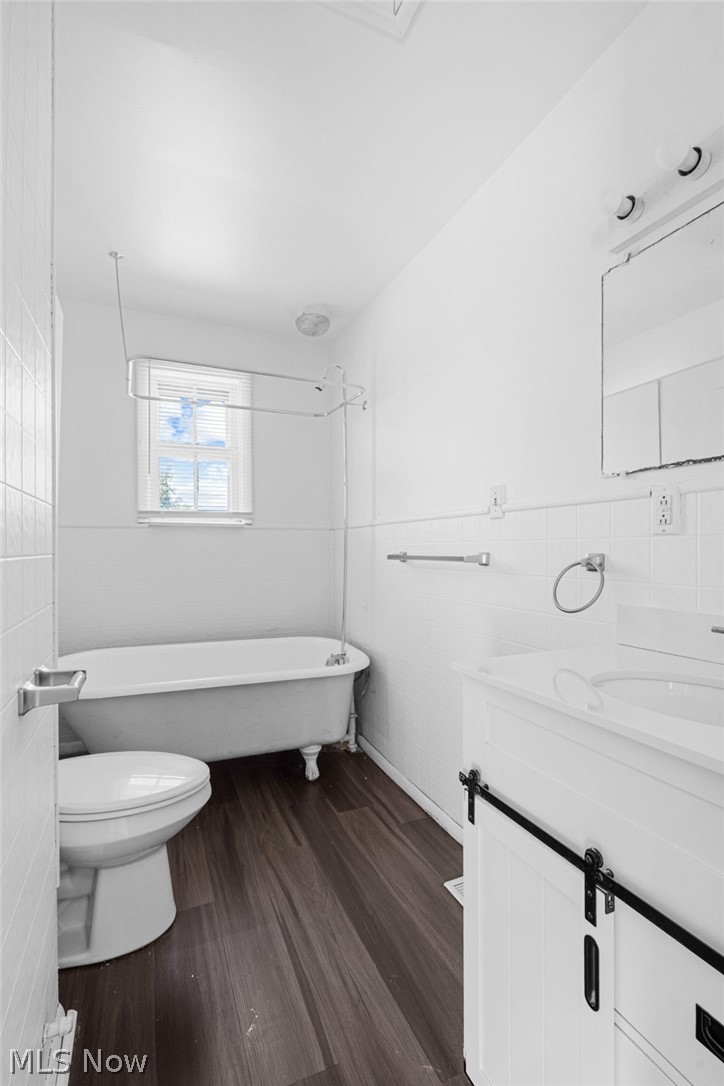 2387 29th Street Southwest Akron, OH 44314 - Photo 24 of 24 Bathroom with vanity, dark wood finished floors, and tile walls