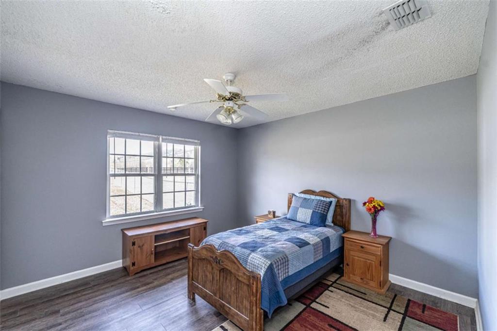 179 Couey Circle Northeast Rome, GA 30161 - Photo 17 of 37 a bedroom with a bed and wooden floor