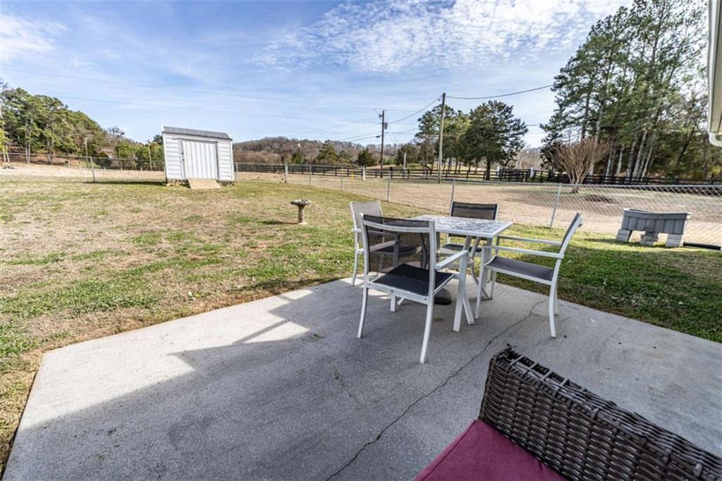 179 Couey Circle Northeast Rome, GA 30161 - Photo 24 of 37 a view of a terrace with chairs and a yard