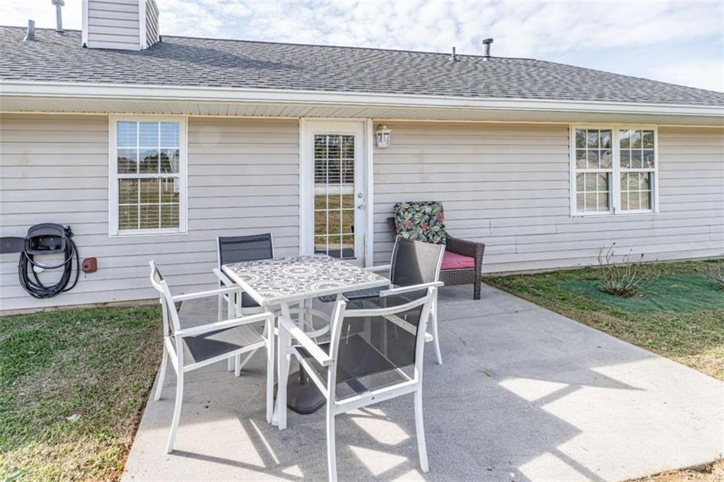179 Couey Circle Northeast Rome, GA 30161 - Photo 25 of 37 a patio with table and chairs and potted plants