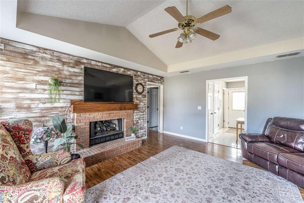 179 Couey Circle Northeast Rome, GA 30161 - Photo 6 of 37 a living room with furniture a flat screen tv and a fireplace
