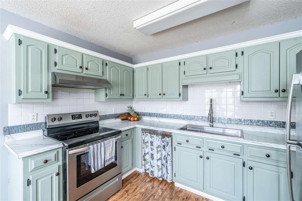 179 Couey Circle Northeast Rome, GA 30161 - Photo 7 of 37 a kitchen with stainless steel appliances a sink stove and cabinets