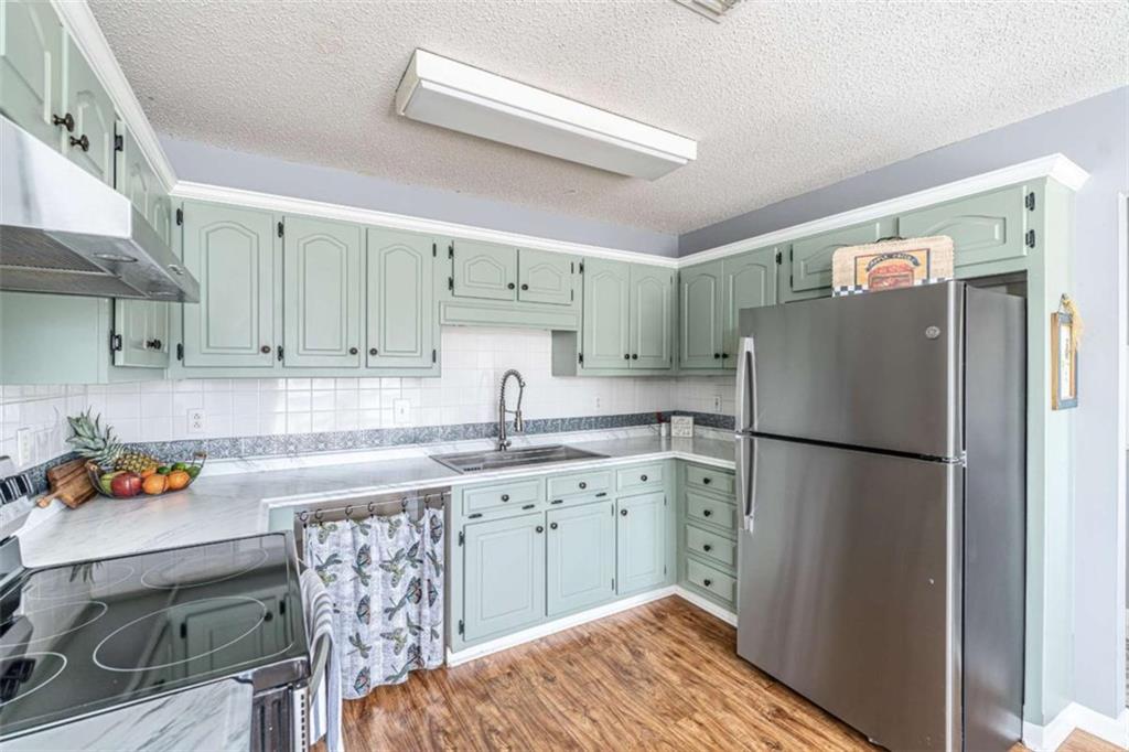 179 Couey Circle Northeast Rome, GA 30161 - Photo 8 of 37 a kitchen with stainless steel appliances a refrigerator a sink a stove a dining table and chairs