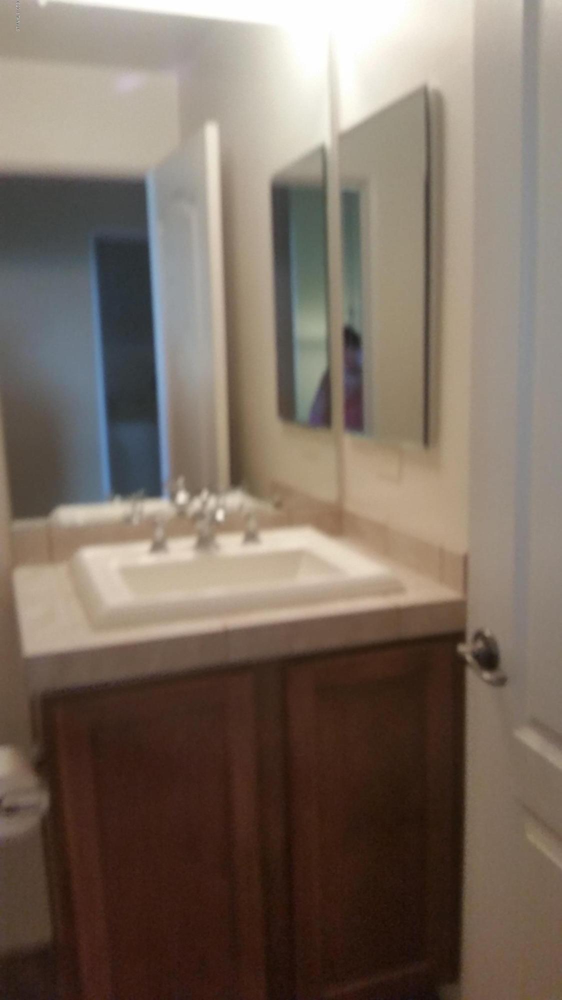 478 East Cedarvale Road Tucson, AZ 85704 - Photo 17 of 39 a bathroom with a sink and a mirror