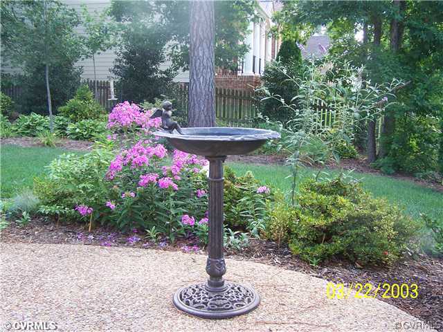 13338 Tipple Point Road Midlothian, VA 23114 - Photo 12 of 12 a front view of a house with a yard and fountain