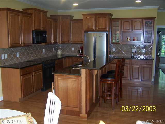 13338 Tipple Point Road Midlothian, VA 23114 - Photo 4 of 12 a kitchen with stainless steel appliances granite countertop a refrigerator and a stove top oven