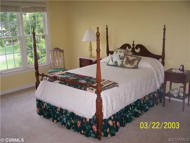 13338 Tipple Point Road Midlothian, VA 23114 - Photo 9 of 12 a bed sitting in a bedroom next to a window