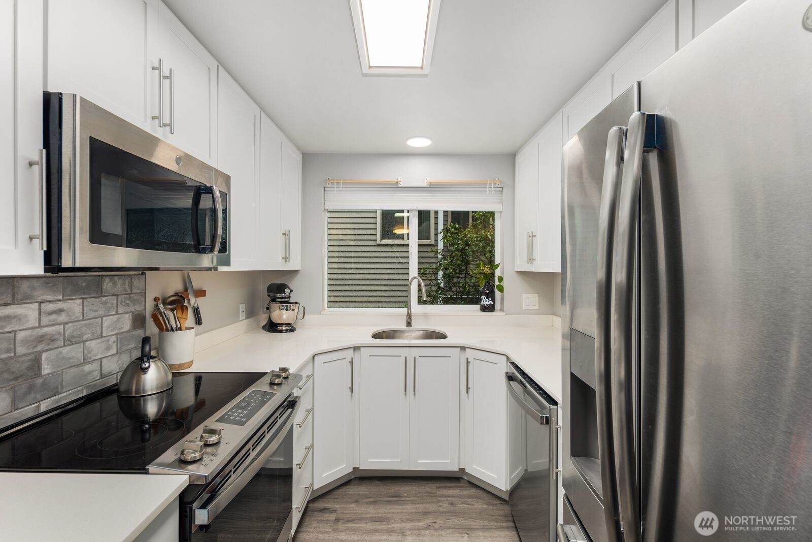 1729 18th Avenue, Unit 201 Seattle, WA 98122 - Photo 12 of 31 a kitchen with a sink stove and microwave