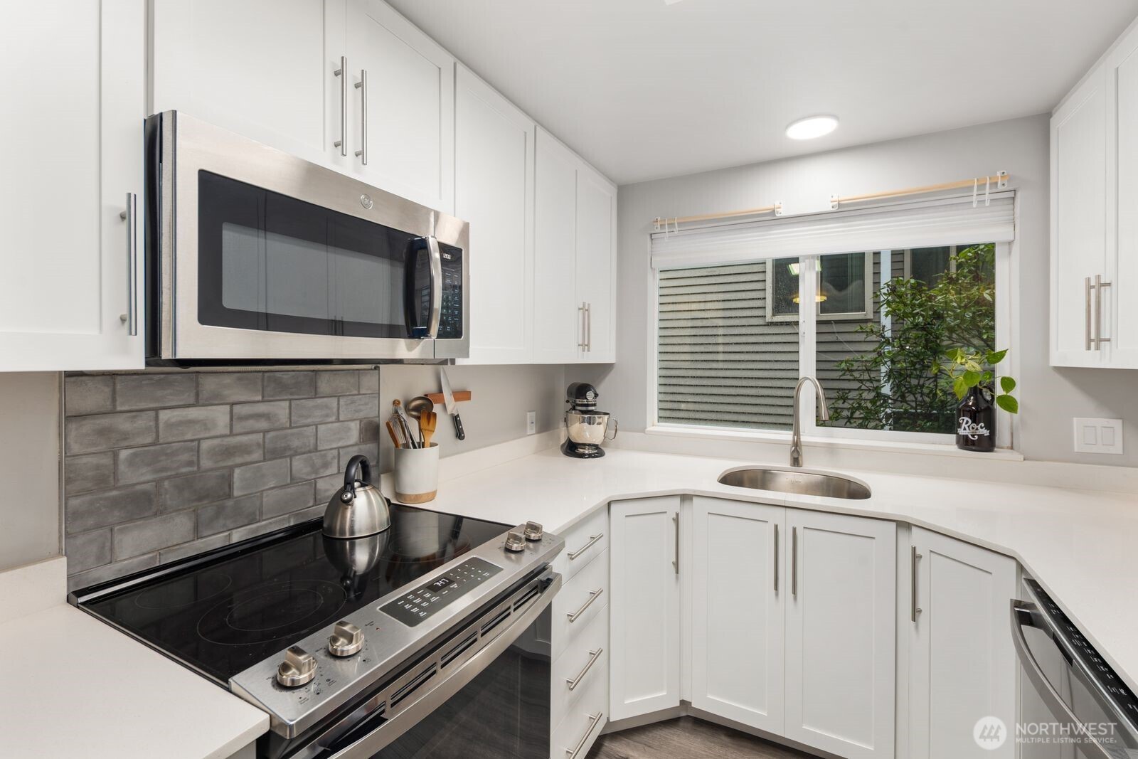 1729 18th Avenue, Unit 201 Seattle, WA 98122 - Photo 13 of 31 a kitchen with a sink stove top oven and cabinets