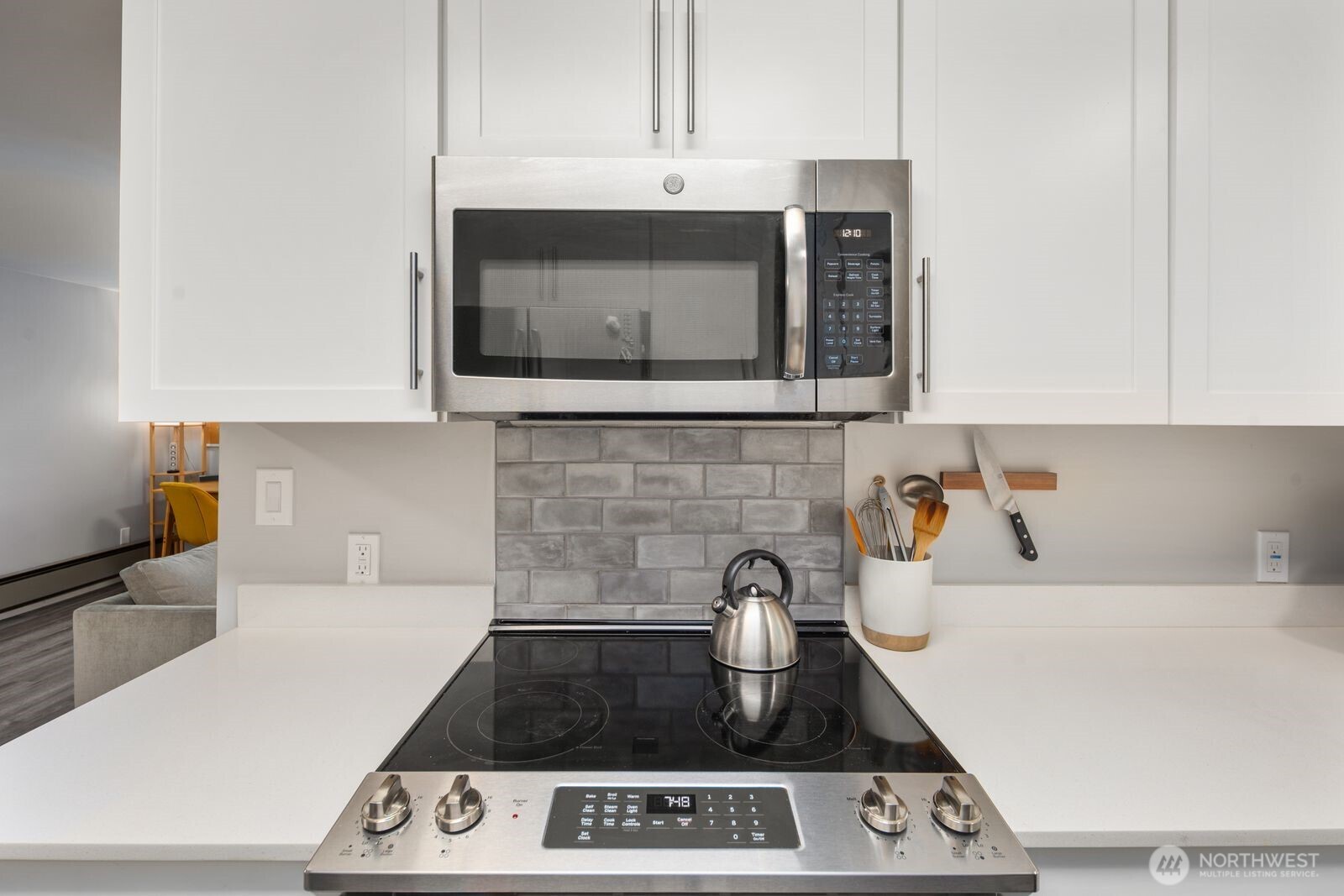 1729 18th Avenue, Unit 201 Seattle, WA 98122 - Photo 15 of 31 a kitchen with a stove and a microwave