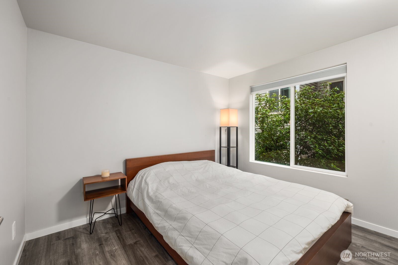 1729 18th Avenue, Unit 201 Seattle, WA 98122 - Photo 18 of 31 a bedroom with a bed and a window