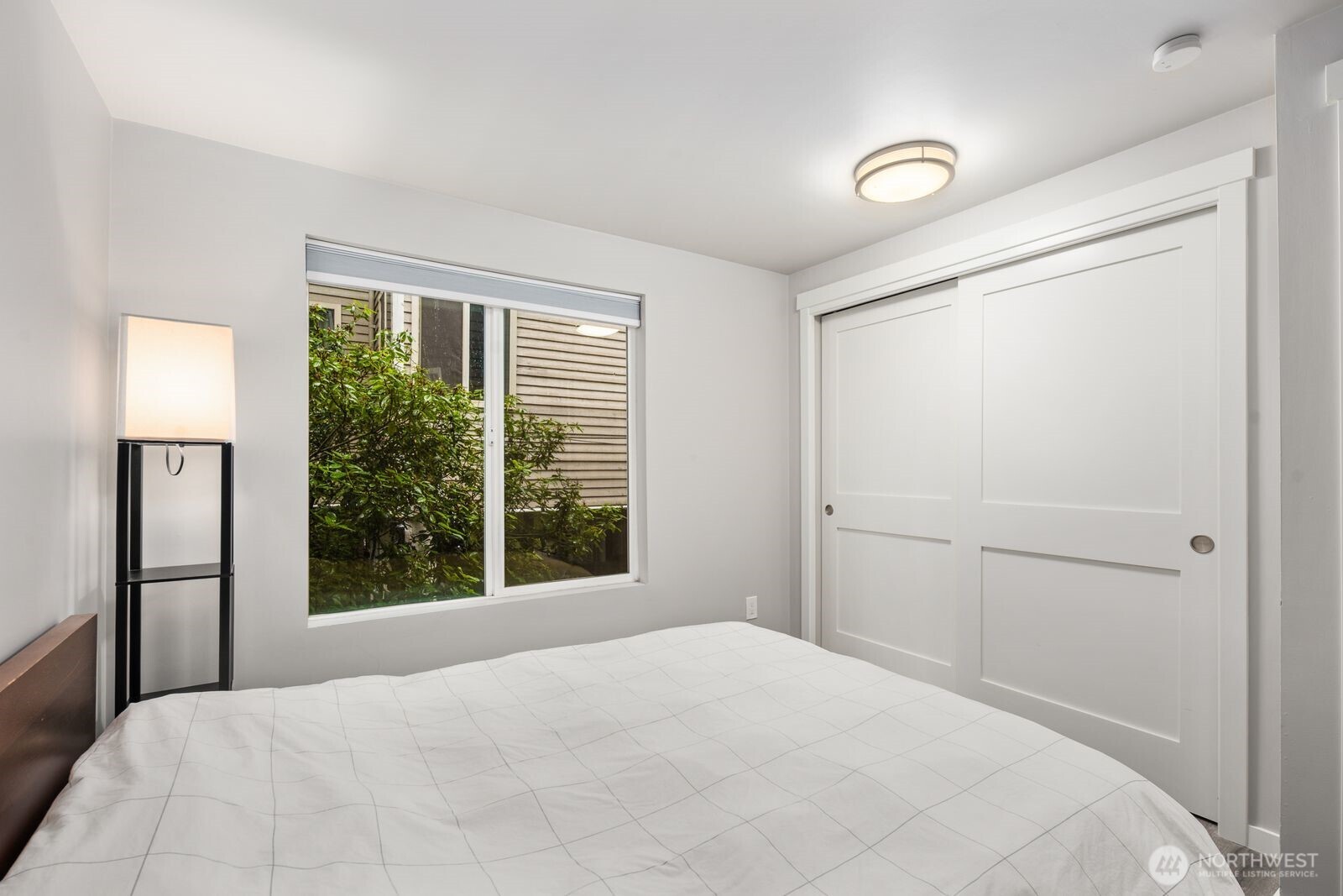 1729 18th Avenue, Unit 201 Seattle, WA 98122 - Photo 19 of 31 a bedroom with a bed and a window