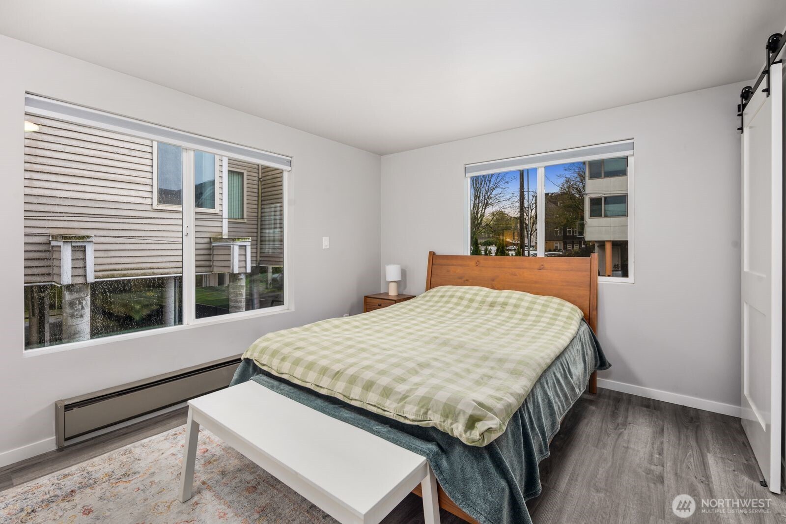 1729 18th Avenue, Unit 201 Seattle, WA 98122 - Photo 20 of 31 a bedroom with a bed and wooden floor