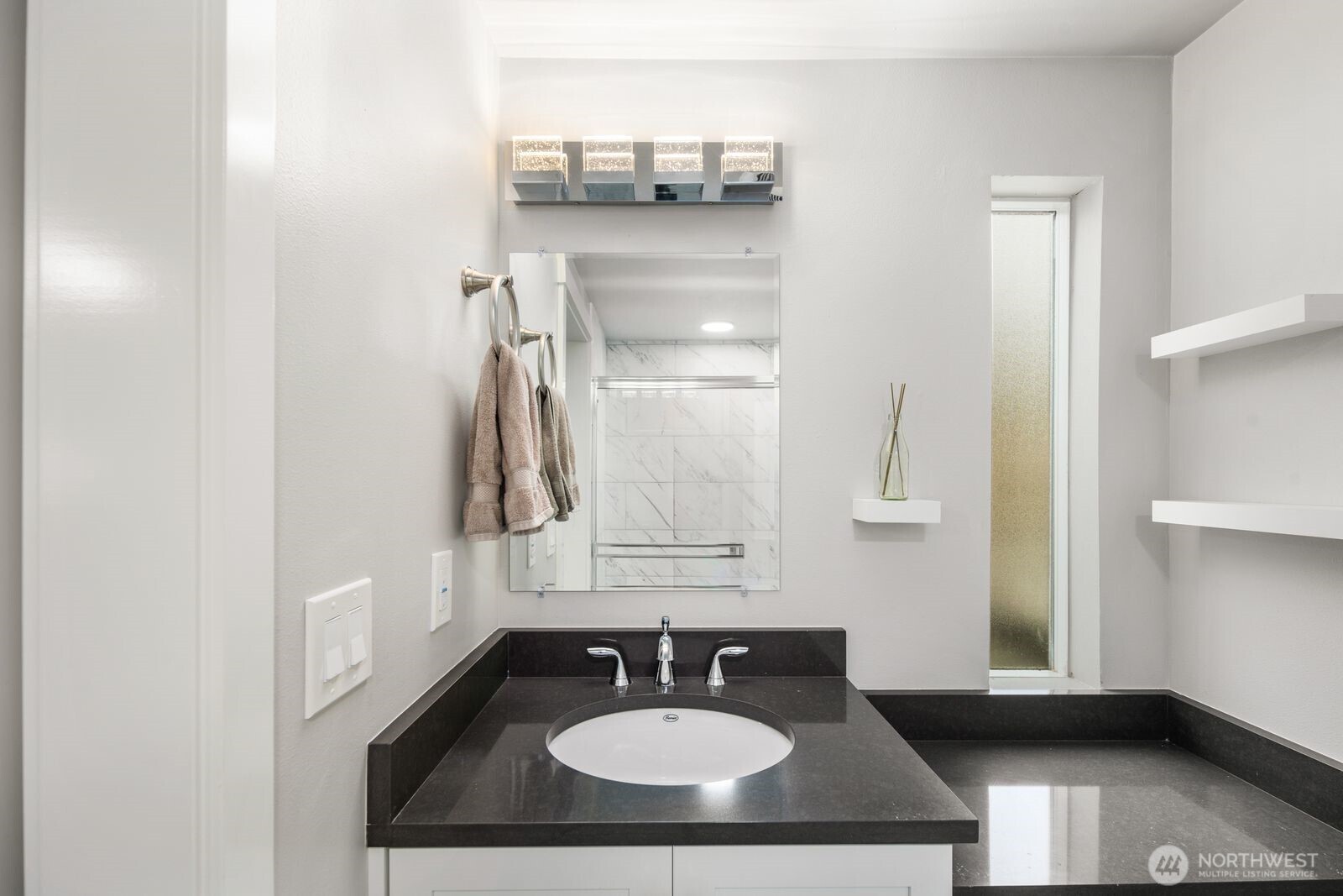 1729 18th Avenue, Unit 201 Seattle, WA 98122 - Photo 24 of 31 a bathroom with a sink and a mirror