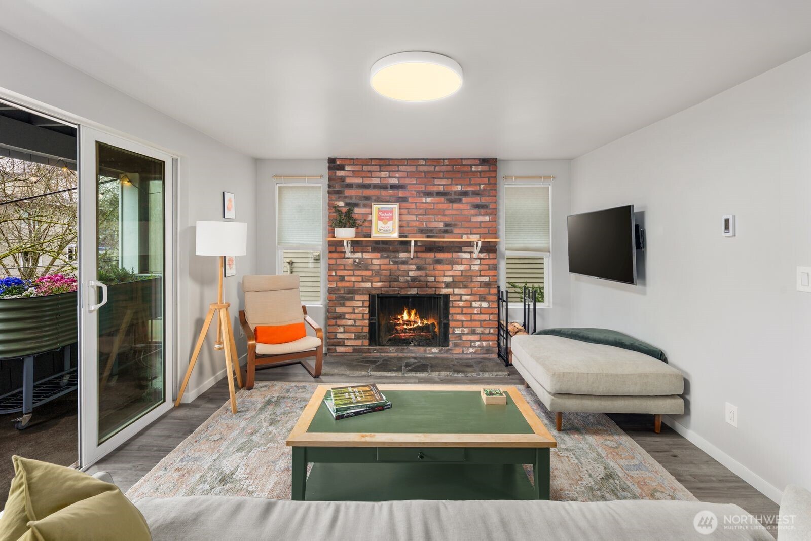 1729 18th Avenue, Unit 201 Seattle, WA 98122 - Photo 5 of 31 a living room with furniture a flat screen tv and a fireplace