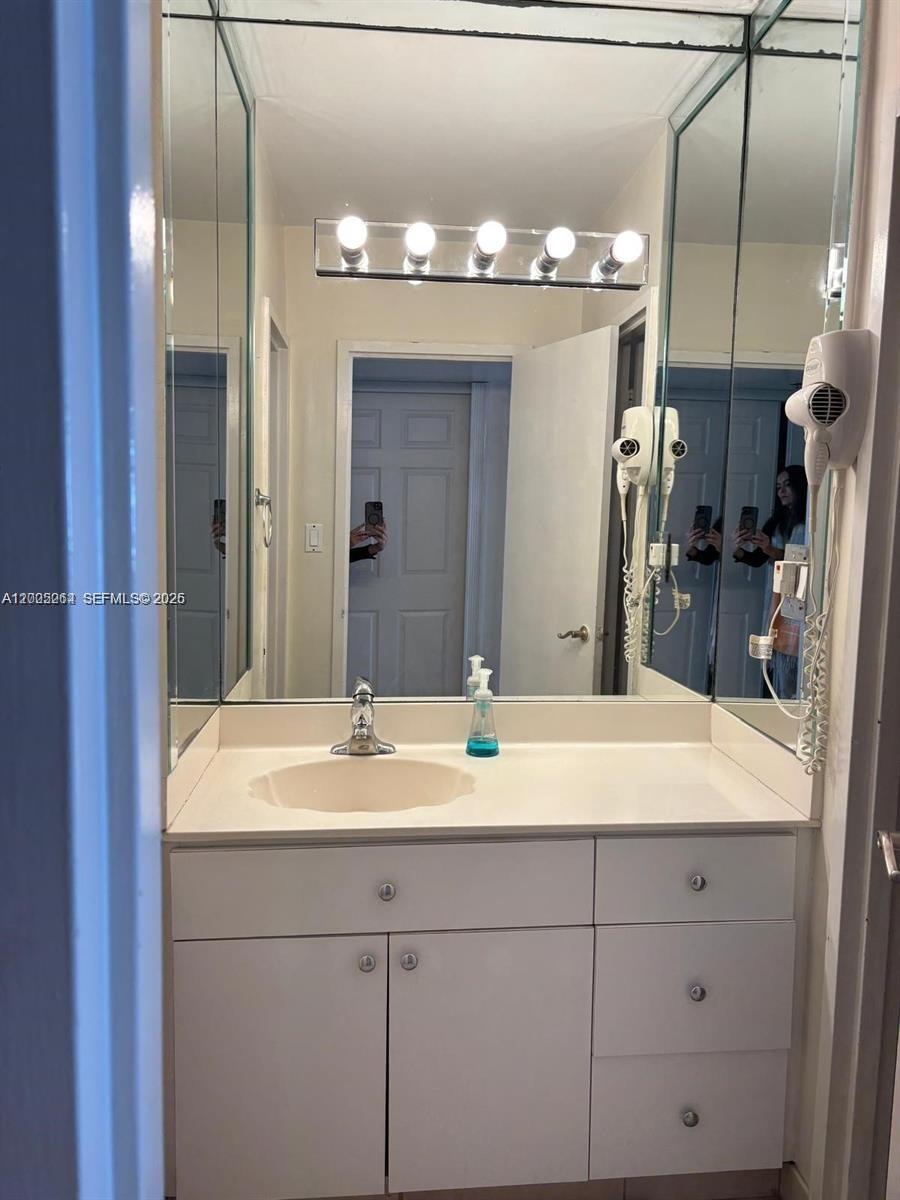 100 Lincoln Road, Unit 731 Miami Beach, FL 33139 - Photo 11 of 14 a bathroom with a sink and a mirror