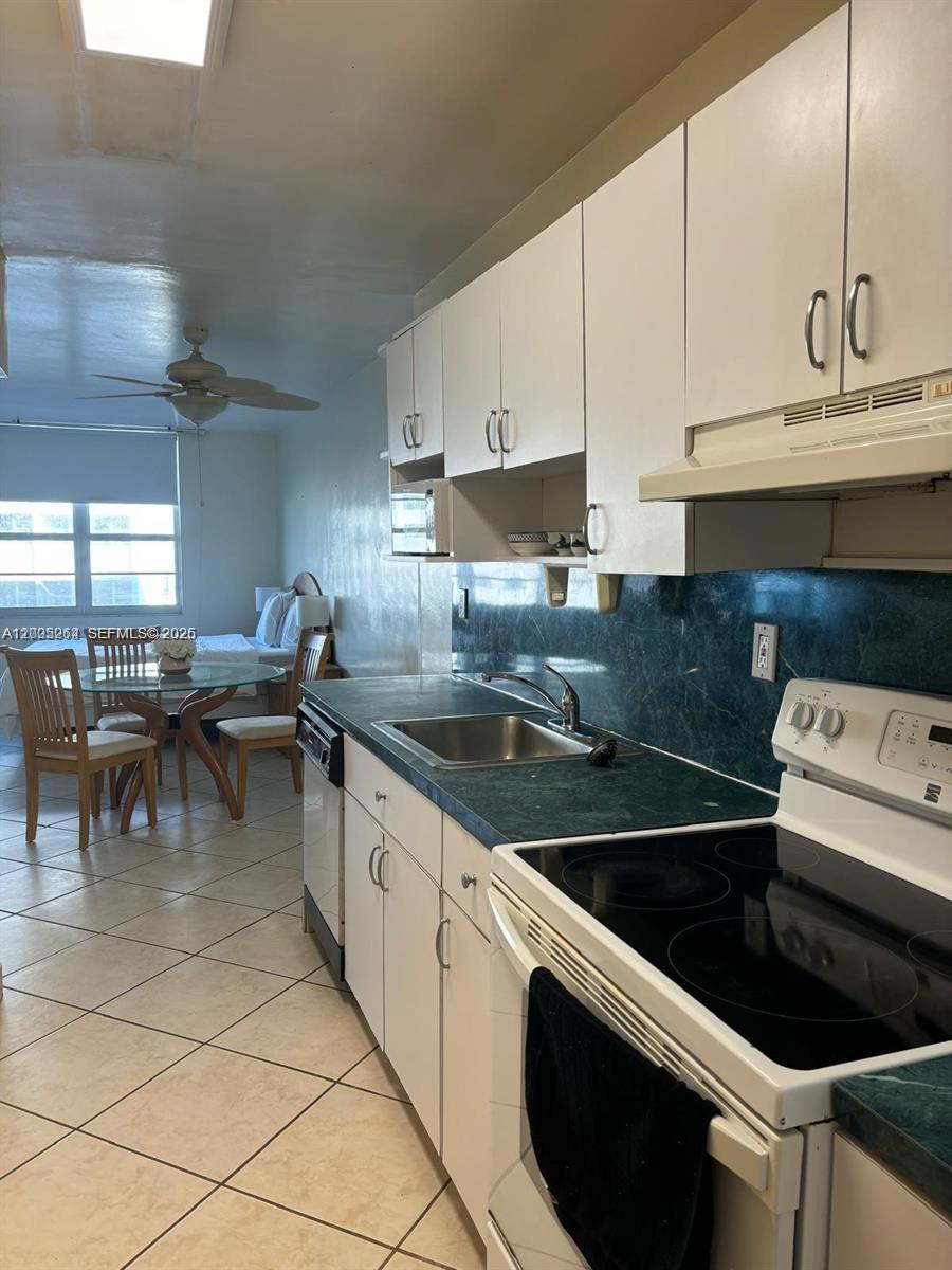 100 Lincoln Road, Unit 731 Miami Beach, FL 33139 - Photo 6 of 14 a kitchen with a sink a stove and cabinets