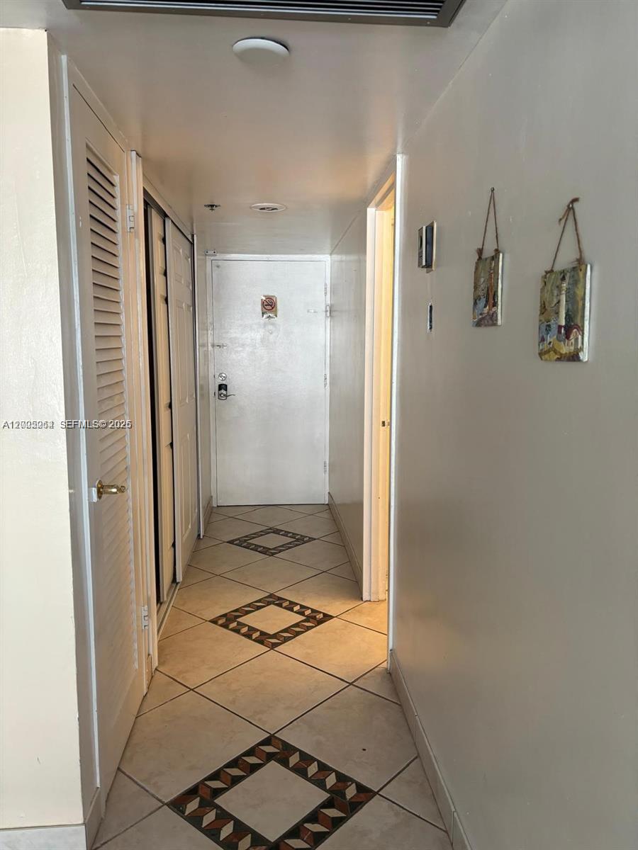 100 Lincoln Road, Unit 731 Miami Beach, FL 33139 - Photo 9 of 14 a view of a hallway with wooden floor and a bathroom